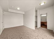 Thumbnail 59 of 71 - a bedroom with gray carpet and white walls at Wilmington Flats Apartments, Utah