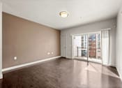 Thumbnail 48 of 71 - a bedroom with hardwood flooring and a balcony at Wilmington Flats Apartments, Salt Lake City, 84106
