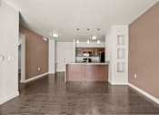 Thumbnail 47 of 71 - an empty living room with a kitchen in the background at Wilmington Flats Apartments, Salt Lake City, UT