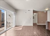 Thumbnail 50 of 71 - a living room with hardwood floors and a glass sliding door to a balcony at Wilmington Flats Apartments, Salt Lake City, Utah