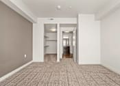 Thumbnail 61 of 71 - a spacious living room with gray walls and a carpeted floor at Wilmington Flats Apartments, Salt Lake City