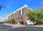Thumbnail 68 of 71 - a large brick building with a garage in front of it at Wilmington Flats Apartments, Salt Lake City, UT, 84106