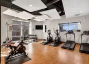 Thumbnail 4 of 71 - a workout room with treadmills and other exercise equipment at Wilmington Flats Apartments, Salt Lake City, UT