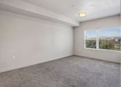 Thumbnail 51 of 71 - an empty bedroom with a large window at Wilmington Flats Apartments, Utah, 84106