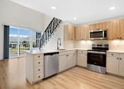 Thumbnail 69 of 144 - A modern kitchen with wooden cabinets and stainless steel appliances.
