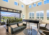 Thumbnail 16 of 144 - A living room with a pool table and a view of the mountains.