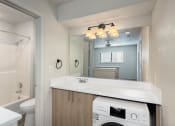 Thumbnail 31 of 50 - a bathroom with a sink and a mirror