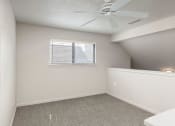 Thumbnail 32 of 50 - a bedroom with a ceiling fan and a window