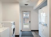 Thumbnail 33 of 50 - a laundry room with a washer and dryer