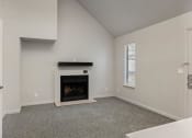 Thumbnail 35 of 50 - a living room with a fireplace and a door