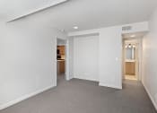 Thumbnail 37 of 50 - the living room and kitchen of an apartment with white walls