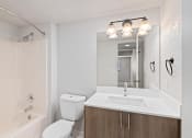 Thumbnail 41 of 50 - a bathroom with a sink toilet and a mirror