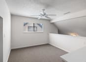Thumbnail 40 of 50 - an empty room with a ceiling fan and a window