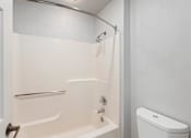 Thumbnail 43 of 50 - a white bathroom with a shower and a toilet