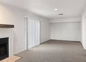 Thumbnail 42 of 50 - an empty living room with a fireplace and white walls