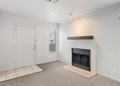 Thumbnail 45 of 50 - a living room with a fireplace and a white door