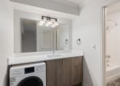 Thumbnail 48 of 50 - a white laundry room with a sink and a washing machine