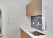 Thumbnail 33 of 51 - a white kitchen with a sink and a refrigerator