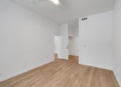 Thumbnail 46 of 51 - the living room and dining room of an apartment with white walls and wood floors