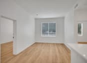 Thumbnail 47 of 51 - a living room and dining room with white walls and wood floors