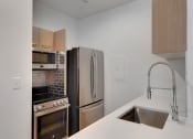Thumbnail 32 of 51 - a kitchen with stainless steel appliances and a sink
