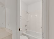 Thumbnail 49 of 51 - a bathroom with a tub and a toilet and a sink
