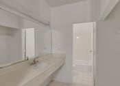 Thumbnail 30 of 51 - a bathroom with a sink and a mirror and a shower