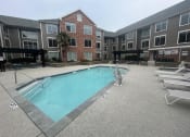 Thumbnail 23 of 51 - a swimming pool in the middle of an apartment building