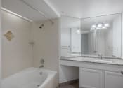 Thumbnail 46 of 56 - a bathroom with a bathtub and a sink