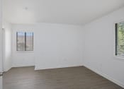 Thumbnail 47 of 56 - a bedroom with white walls and wood floors