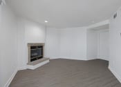 Thumbnail 49 of 56 - a living room with a fireplace and white walls