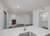 Thumbnail 51 of 56 - a kitchen with a sink and a fireplace in the background