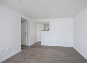 Thumbnail 52 of 56 - an empty room with white walls and a wooden floor