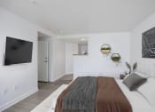 Thumbnail 33 of 56 - a bedroom with a bed and a television on the wall