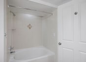 Thumbnail 53 of 56 - a white bath tub sitting next to a white door
