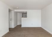 Thumbnail 42 of 56 - a bedroom with white walls and a wooden floor