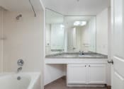 Thumbnail 41 of 56 - a bathroom with a bathtub and a sink