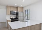Thumbnail 56 of 56 - a kitchen with a large white counter top
