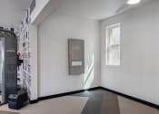 Thumbnail 29 of 56 - a white room with a window on the left and a black door on the right
