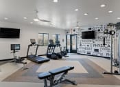 Thumbnail 24 of 56 - a gym with treadmills and other exercise equipment and flat screen televisions