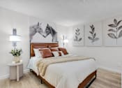 Thumbnail 9 of 61 - a bedroom with a bed and paintings of horses at AVIA Lofts on Liberty Ridge, Florida, 32256