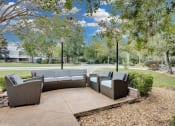 Thumbnail 42 of 61 - a patio with couches and chairs and trees at AVIA Lofts on Liberty Ridge, Florida, 32256