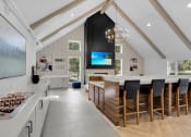 Thumbnail 24 of 61 - a kitchen with a large island and a table with chairs at AVIA Lofts on Liberty Ridge, Florida