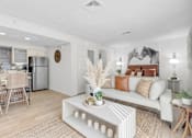 Thumbnail 8 of 61 - a living room with a couch and a table at AVIA Lofts on Liberty Ridge, Florida, 32256
