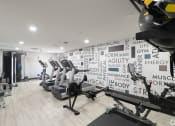 Thumbnail 17 of 34 - a gym with various machines and a wall with words on it