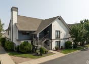 Thumbnail 5 of 34 - an exterior view of a white house with a porch and a staircase