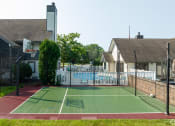 Thumbnail 3 of 34 - a tennis court in front of a house with a pool