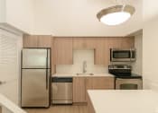 Thumbnail 21 of 34 - the preserve at ballantyne commons apartment kitchen with stainless steel appliances