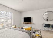Thumbnail 11 of 45 - a bedroom with a bed and a tv and a mirror