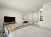Thumbnail 12 of 45 - a bedroom with a bed and a desk and a television